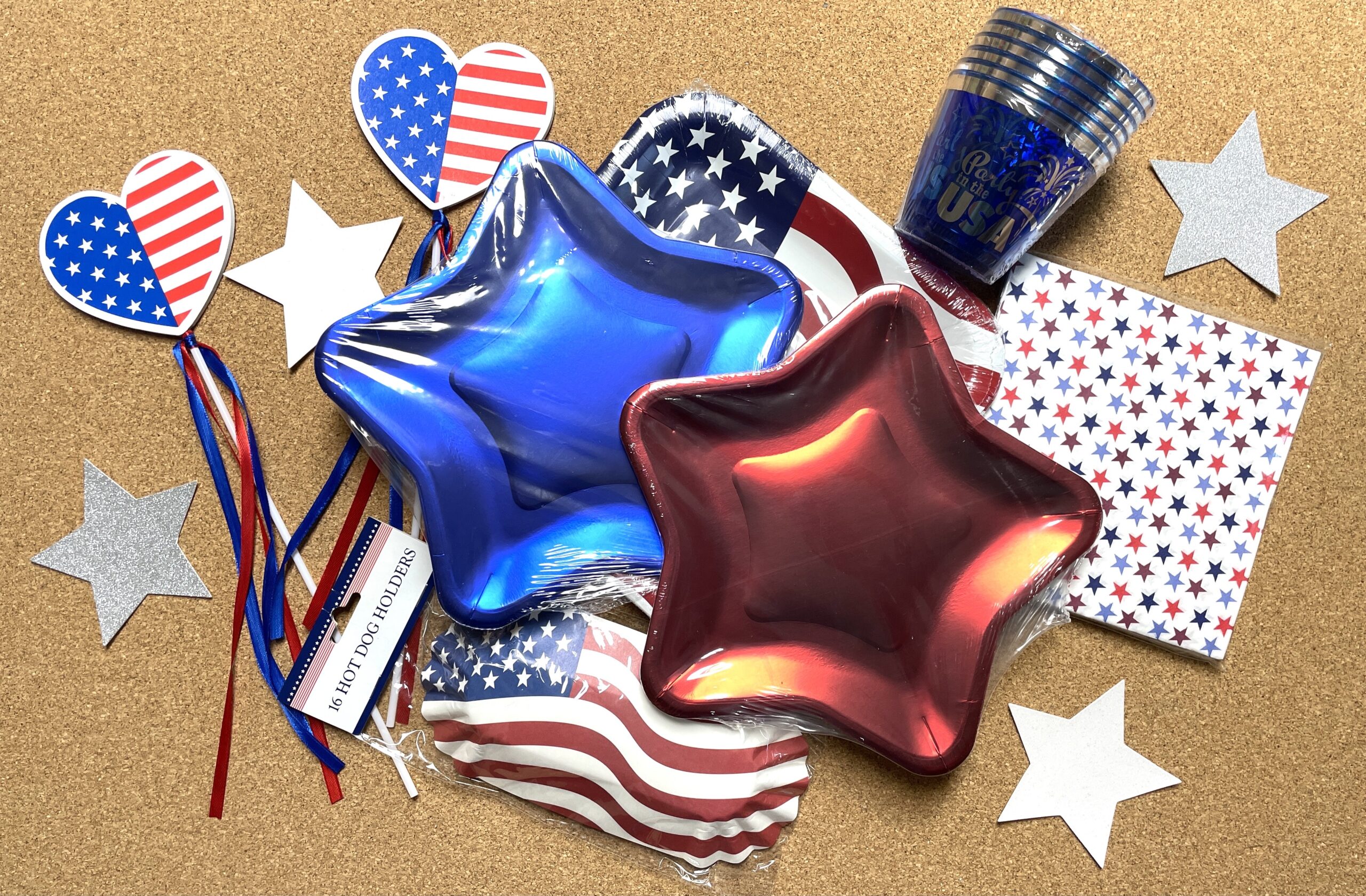 Paper plates, cups, napkins, and hot dog holders in red, white, and blue with stars and stripes